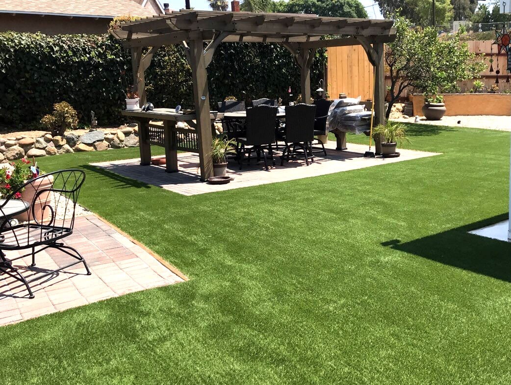 Backyard with artificial grass installed